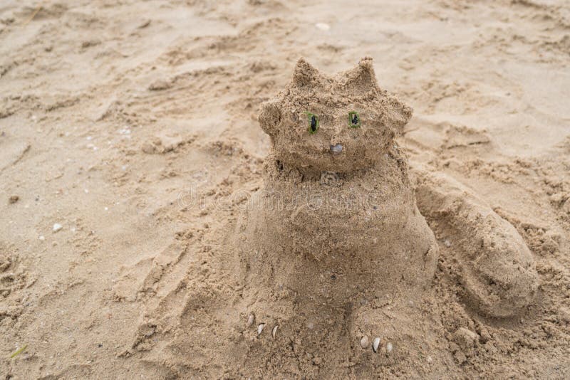Funny Sand Sculpture of a Cat on the Beach. Summer Holidays Stock Image