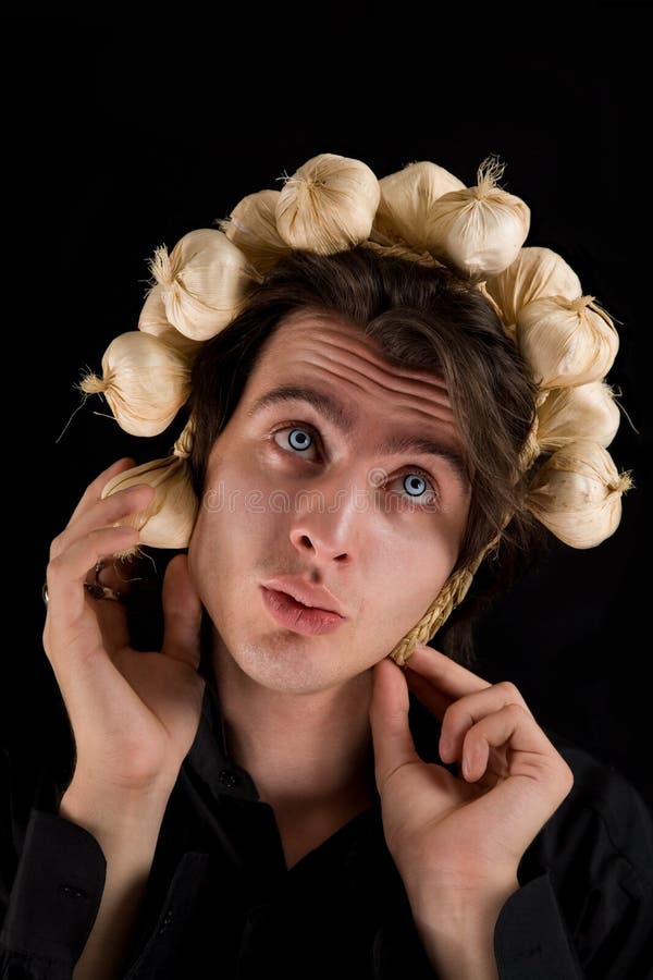 Funny shot of vampire with garlic on his head royalty free stock photography