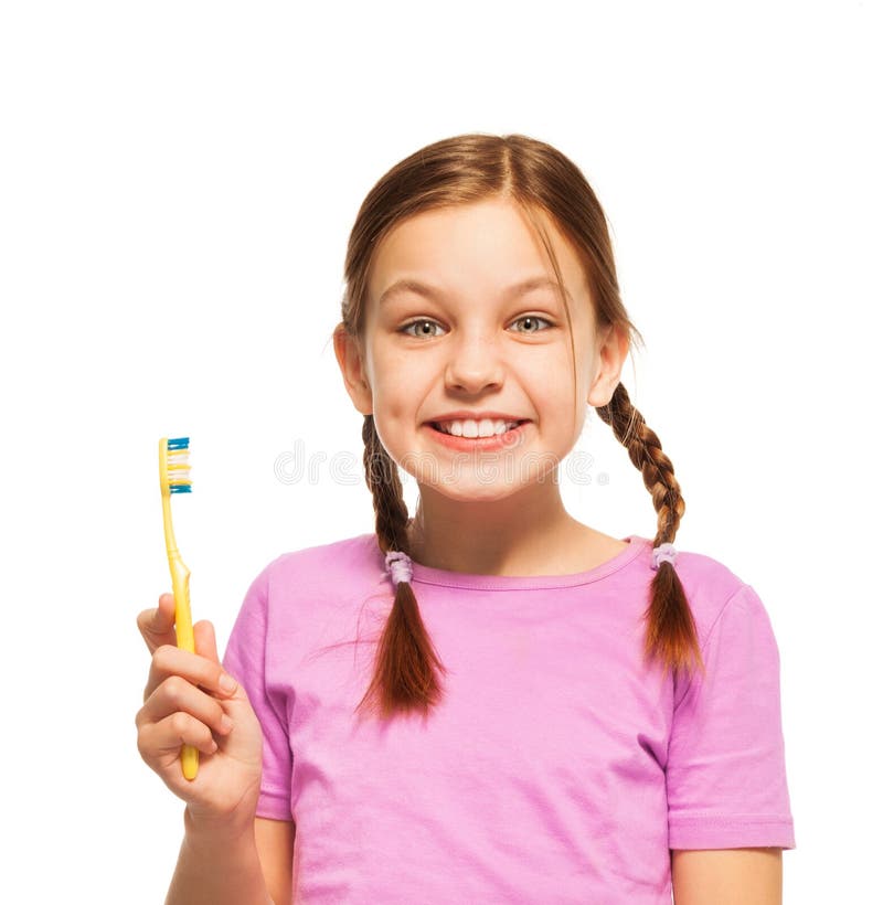Funny teenage girl in pink tee brushing her teeth stock photo Funny teenage girl in pink tee brushing her teeth stock photo