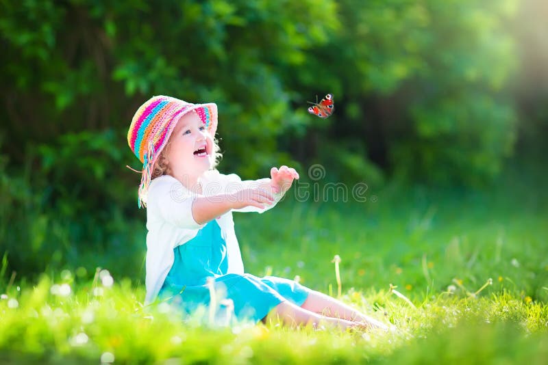 Funny toddler girl playing with butterfly