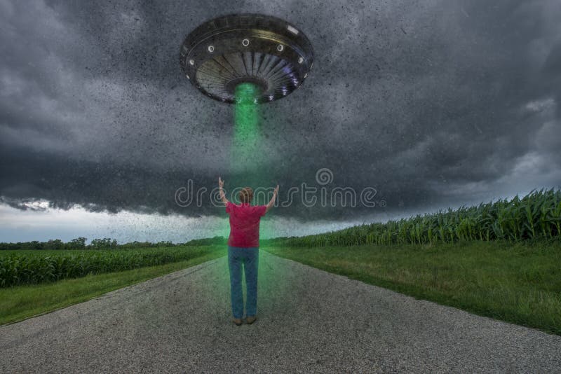An old elderly senior woman is having a UFO alien outer space alien abduction. The lady is on a lonely road and meeting with aliens. An old elderly senior woman is having a UFO alien outer space alien abduction. The lady is on a lonely road and meeting with aliens.