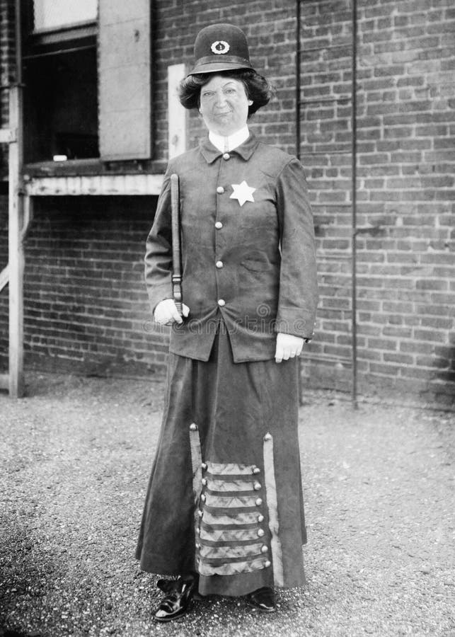 Funny Vintage Cop, Police, Policewoman, Woman. Funny vintage retro cop, police, or policewoman. The woman law enforcement officer has a serious and goofy look on stock photo Funny Vintage Cop, Police, Policewoman, Woman. Funny vintage retro cop, police, or policewoman. The woman law enforcement officer has a serious and goofy look on stock photo