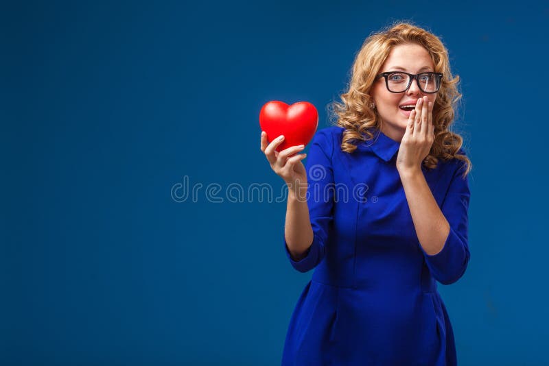 Funny woman holding heart shape