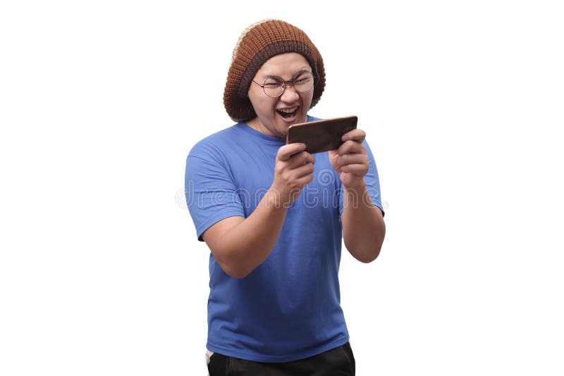 Funny Young Asian Guy Playing Games on Tablet Smart Phone royalty free stock photo Funny Young Asian Guy Playing Games on Tablet Smart Phone royalty free stock photo