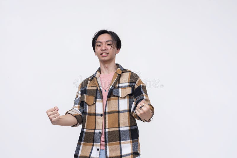 A funny young asian man powering up with his thin lanky body, pretending to be an super powered anime character. stock image