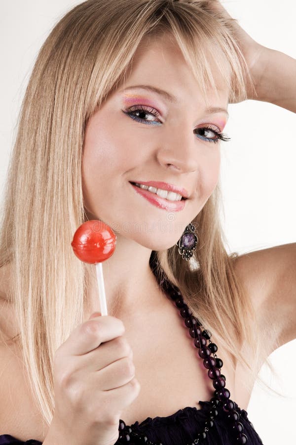 Funny young woman with a lollipop