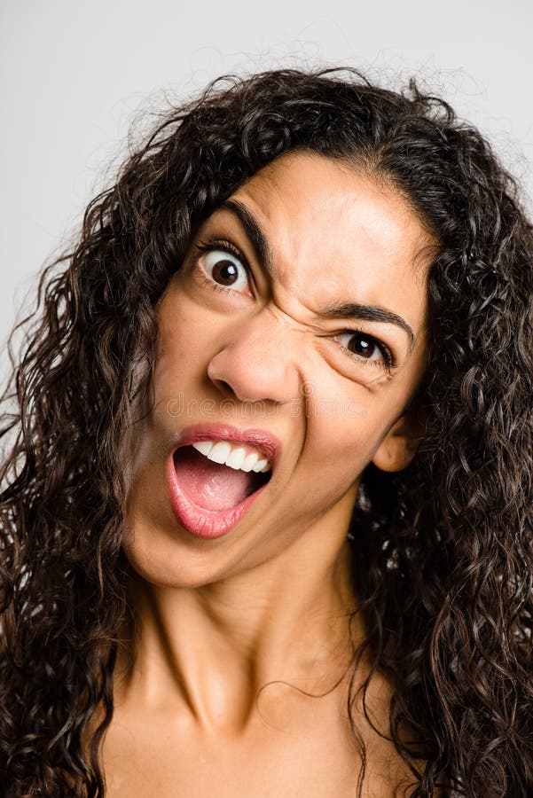 Funny woman portrait real people high definition grey background. Funny young woman pulling faces royalty free stock photo Funny woman portrait real people high definition grey background. Funny young woman pulling faces royalty free stock photo