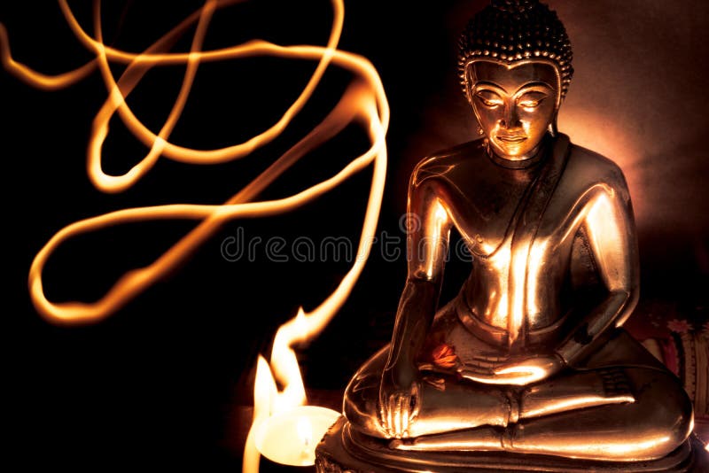 Selective focus of buddha statue with blurred burning candle light in soft night light with line light . Concept of peace, meditation, hope and relaxation. Selective focus of buddha statue with blurred burning candle light in soft night light with line light . Concept of peace, meditation, hope and relaxation.