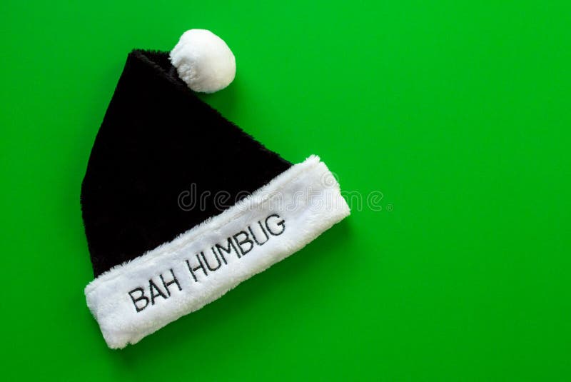 Fur brim of a hat with the words Bah Humbug on it in black and white isolated on a green background. Fur brim of a hat with the words Bah Humbug on it in black and white isolated on a green background