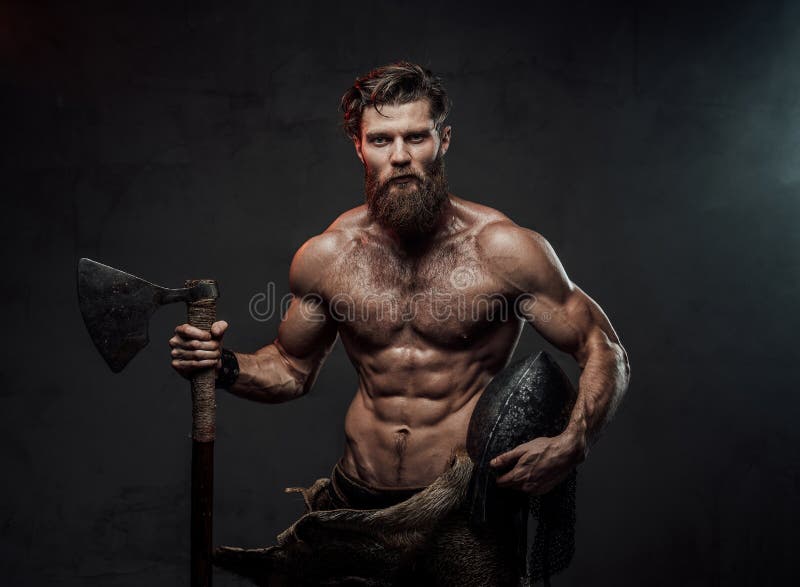 Medieval viking with axe and helmet in dark background