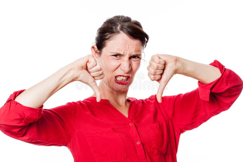 Furious young woman with disappointed thumbs down grinding teeth royalty free stock photo Furious young woman with disappointed thumbs down grinding teeth royalty free stock photo