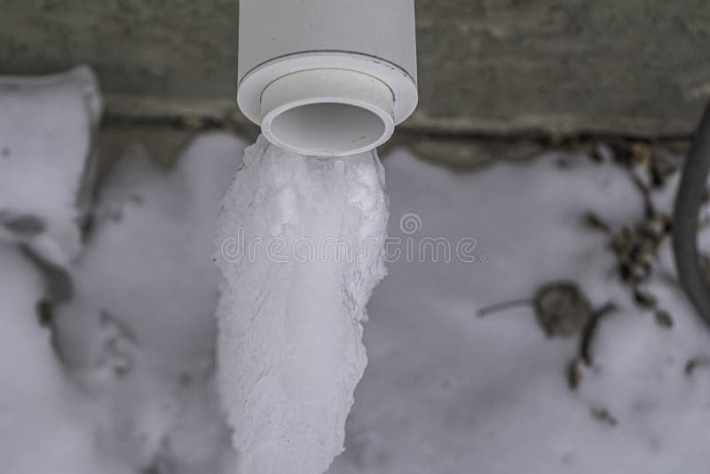 Furnace Exhaust Vent with Icicle from Dripping Water Stock Photo