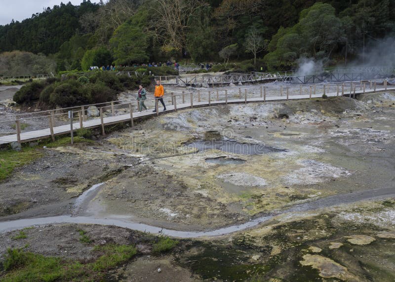 Furnas, Sao Miguel, het eiland van de Azoren, Portugal, 22 December, 2018: Toeristen die op de stoom van de Hete lentes letten en stock fotografie Furnas, Sao Miguel, het eiland van de Azoren, Portugal, 22 December, 2018: Toeristen die op de stoom van de Hete lentes letten en stock fotografie