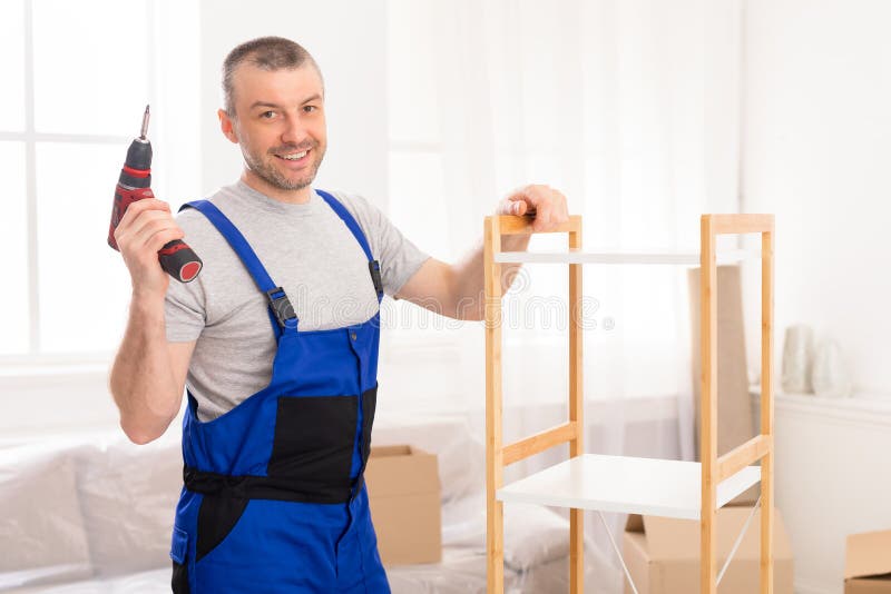 https://thumbs.dreamstime.com/b/furniture-assembler-posing-electric-drill-assembling-cabinet-indoor-man-working-smiling-to-camera-copy-space-185063273.jpg