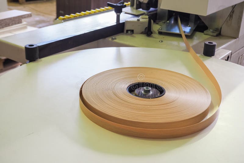 At A Furniture Factory Edge Plastic Roll Is Fed Into An Edge