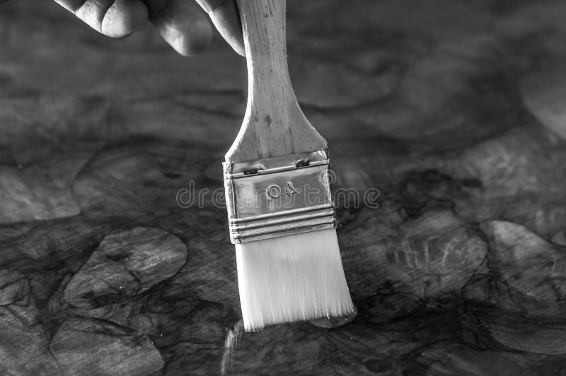 Furniture Restoration. Hand Oiling a Wood Table with a Brush Stock