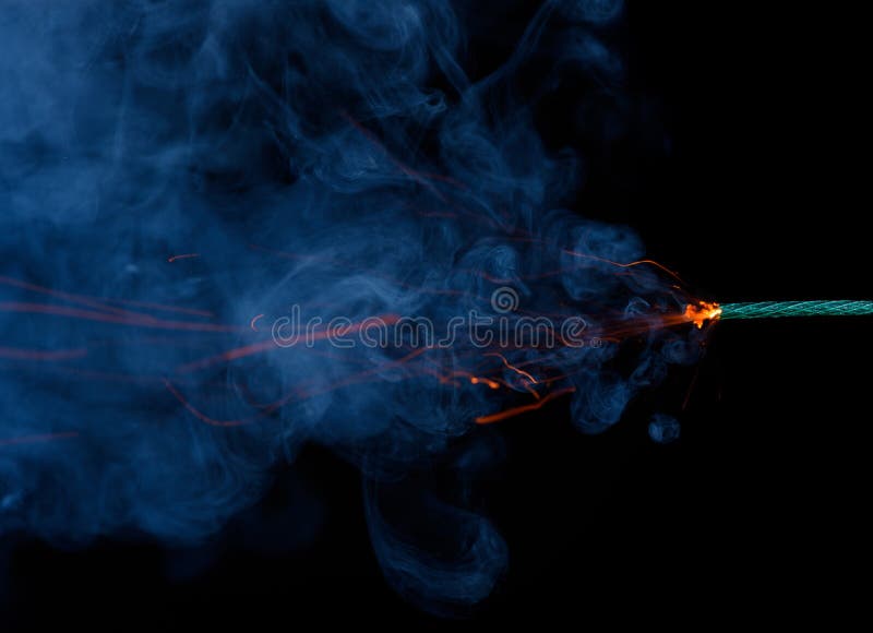 Burning fuse. Dynamite firecracker green fuse burn with sparkles and smoke  on black background. Stock Photo