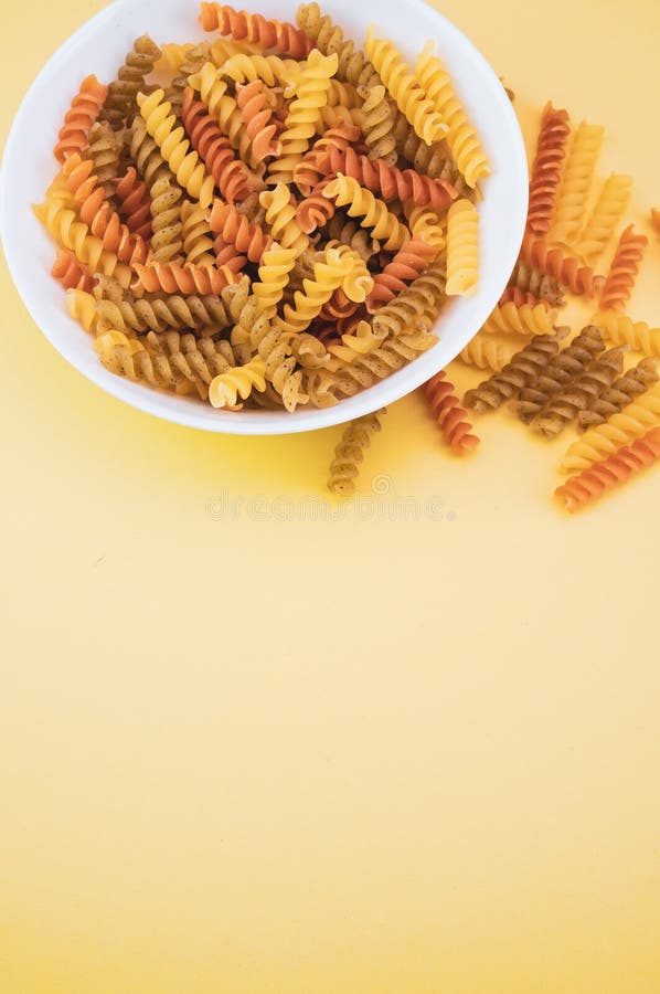 Fusilli Pasta in the Bowl on the Yellow Surface Stock Image Image of