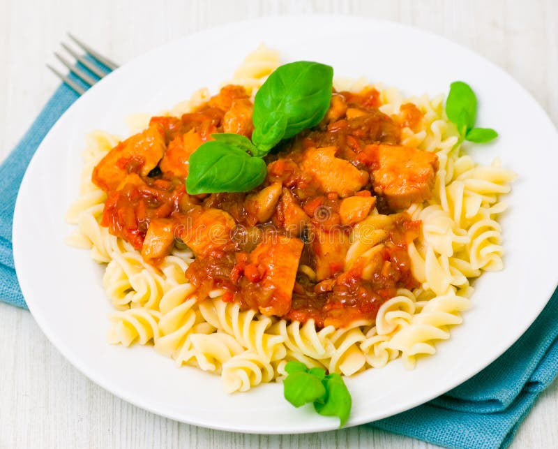 Fusilli pasta with chicken breast in tomato sauce
