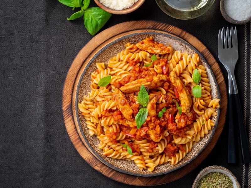 Fusilli Pasta with Tomato Sauce, Chicken Fillet with Basil Leave Stock ...