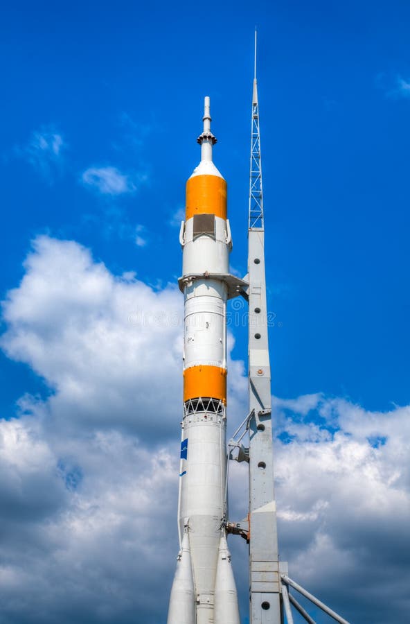 Space rocket ready to go at the start bed with blue cloudy sky in background. Space rocket ready to go at the start bed with blue cloudy sky in background