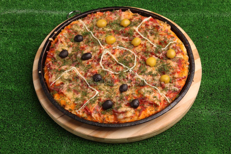 Italian Football pizza on green field. Italian Football pizza on green field