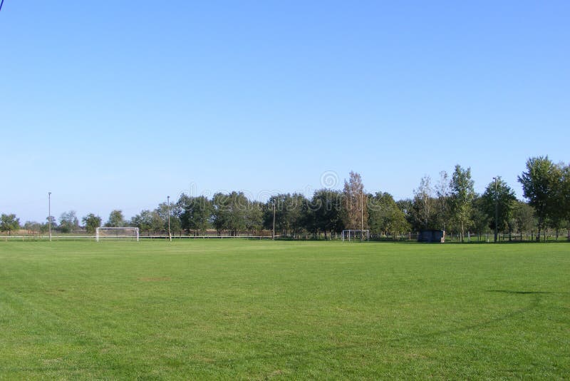 Futebol rural, passo tomado do anfiteatro em uma mola ensolarada, dia do futebol de verões fotografia de stock Futebol rural, passo tomado do anfiteatro em uma mola ensolarada, dia do futebol de verões fotografia de stock