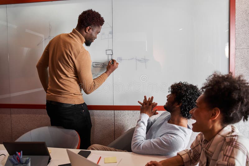 Future male designer or blogger creating something while standing near the board royalty free stock photo