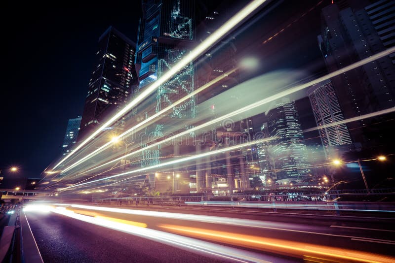 Futuristic night cityscape view with illuminated skyscrapers and city traffic across street. Hong Kong. Futuristic night cityscape view with illuminated skyscrapers and city traffic across street. Hong Kong