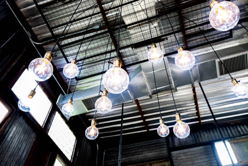 Futuristic blue energy lighting balls chandelier, glow like an arc reactor. Hanging from metal ceiling. Futuristic blue energy lighting balls chandelier, glow like an arc reactor. Hanging from metal ceiling