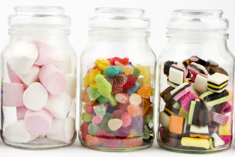 Glass bottles filled with assorted sweets including marshmallows, liquorice and sugar coated jellies. Glass bottles filled with assorted sweets including marshmallows, liquorice and sugar coated jellies