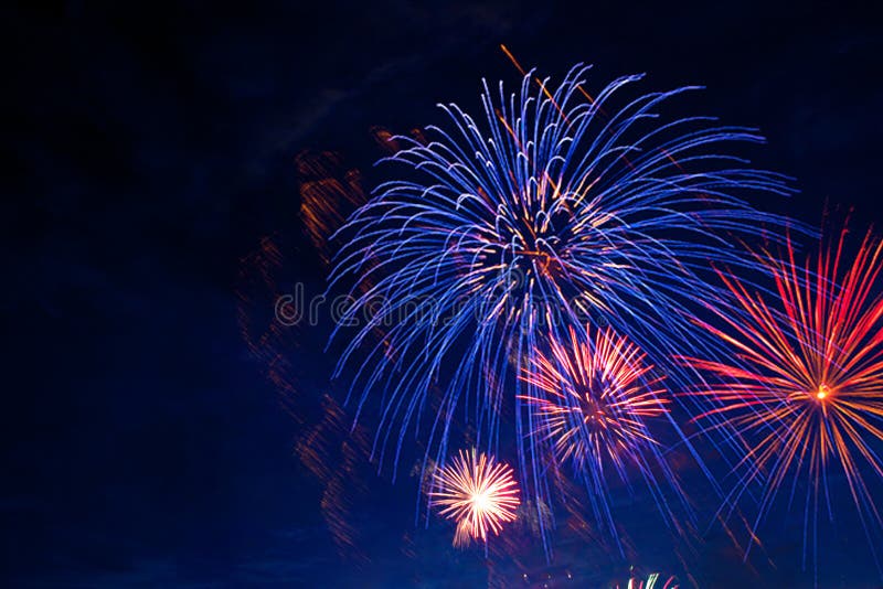 Fireworks in sky twilight. Fireworks display on dark sky background. Independence Day, 4th of July, Fourth of July or New Year. Fireworks in sky twilight. Fireworks display on dark sky background. Independence Day, 4th of July, Fourth of July or New Year.