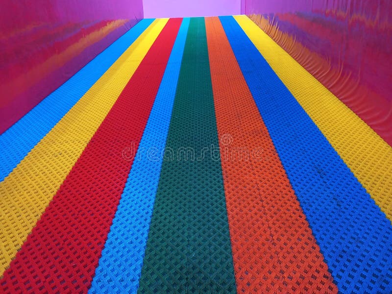 Colorful rainbow slide with rough-textured on its surface at indoor playground. Colorful rainbow slide with rough-textured on its surface at indoor playground.