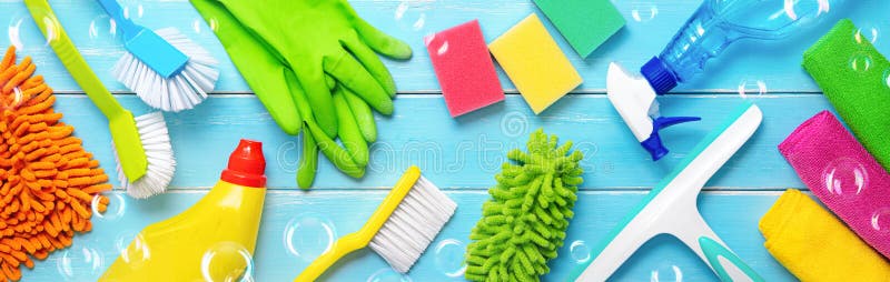 Colorfull cleaning items on blue wooden planks with the soapbubbles. Colorfull cleaning items on blue wooden planks with the soapbubbles