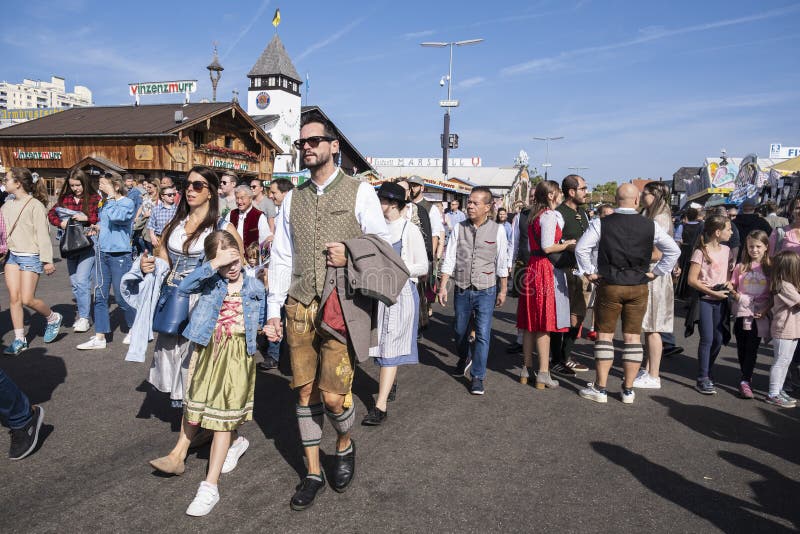 Munich, Germany - October 1, 2023. People at Oktoberfest 2023, the world-famous beer festival in the Bavarian culture called d' Wiesn, in Munich, Deutschland. Munich, Germany - October 1, 2023. People at Oktoberfest 2023, the world-famous beer festival in the Bavarian culture called d' Wiesn, in Munich, Deutschland.