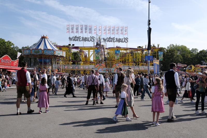 Munich, Germany - October 1, 2023. People at Oktoberfest 2023, the world-famous beer festival in the Bavarian culture called d' Wiesn, in Munich, Deutschland. Munich, Germany - October 1, 2023. People at Oktoberfest 2023, the world-famous beer festival in the Bavarian culture called d' Wiesn, in Munich, Deutschland.