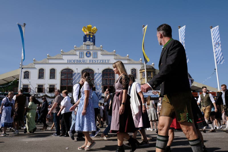 Munich, Germany - October 1, 2023. People at Oktoberfest 2023, the world-famous beer festival in the Bavarian culture called d' Wiesn, in Munich, Deutschland. Munich, Germany - October 1, 2023. People at Oktoberfest 2023, the world-famous beer festival in the Bavarian culture called d' Wiesn, in Munich, Deutschland.