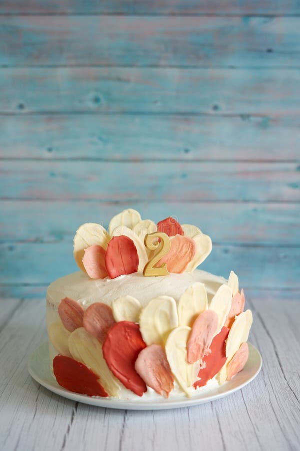 Birthday biscuit cake stands on a light wooden table. Caption: 2. High quality photo. Birthday biscuit cake stands on a light wooden table. Caption: 2. High quality photo