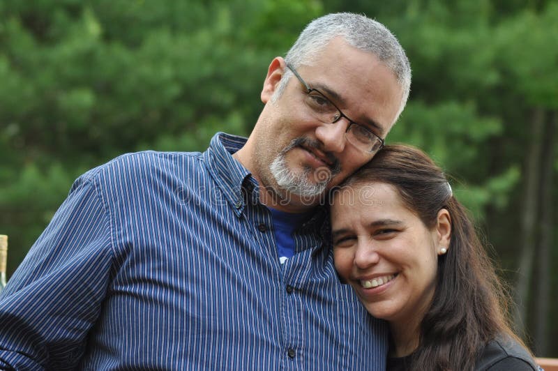 A middle-aged couple is proud of being together for a long time. They are celebrating their wedding anniversary. A middle-aged couple is proud of being together for a long time. They are celebrating their wedding anniversary.