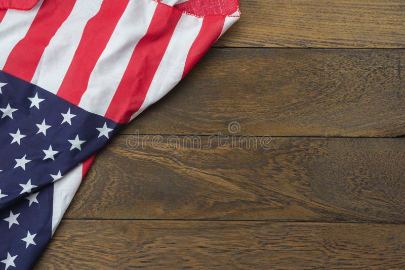 Table top view 4 th July independence day holiday background concept.Flat lay USA flag for sign of season on modern rustic brown wooden at office desk.Free space for creative design text & content. Table top view 4 th July independence day holiday background concept.Flat lay USA flag for sign of season on modern rustic brown wooden at office desk.Free space for creative design text & content.