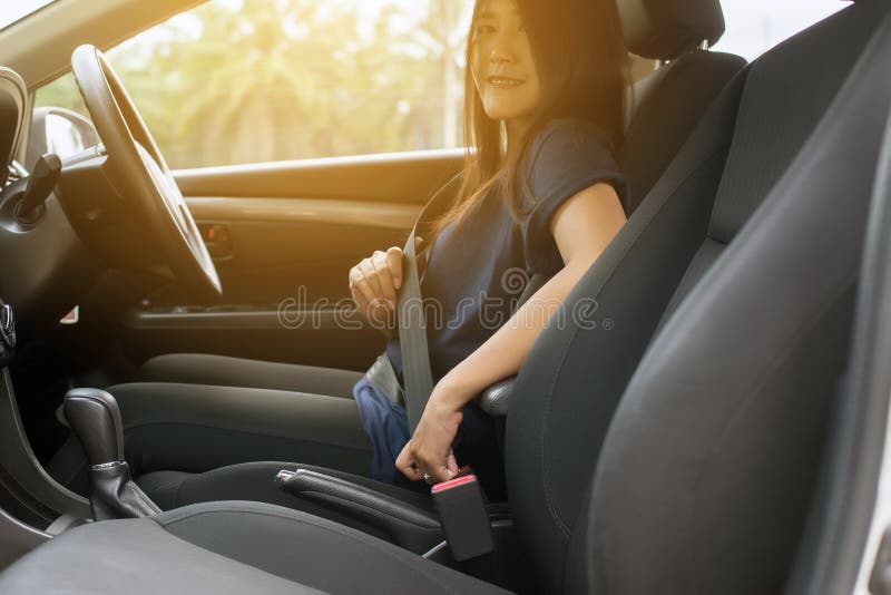 För kvinnachaufför för händer asiatiskt fästande eller sättasäkerhetsbälte i bil-, trans.- och medelsäkerhetsbegrepp arkivfoto För kvinnachaufför för händer asiatiskt fästande eller sättasäkerhetsbälte i bil-, trans.- och medelsäkerhetsbegrepp arkivfoto