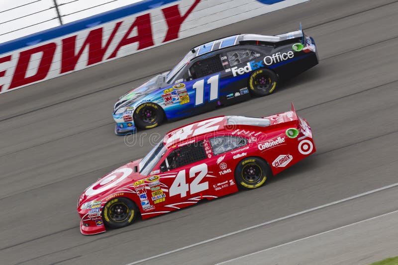 FONTANA, CA - MAR 27, 2011: Denny Hamlin (11) and Juan Pablo Montoya (42) battle for position during the Auto Club 400 NASCAR Sprint Cup race at the Auto Club Speedway in Fontana, CA. FONTANA, CA - MAR 27, 2011: Denny Hamlin (11) and Juan Pablo Montoya (42) battle for position during the Auto Club 400 NASCAR Sprint Cup race at the Auto Club Speedway in Fontana, CA.