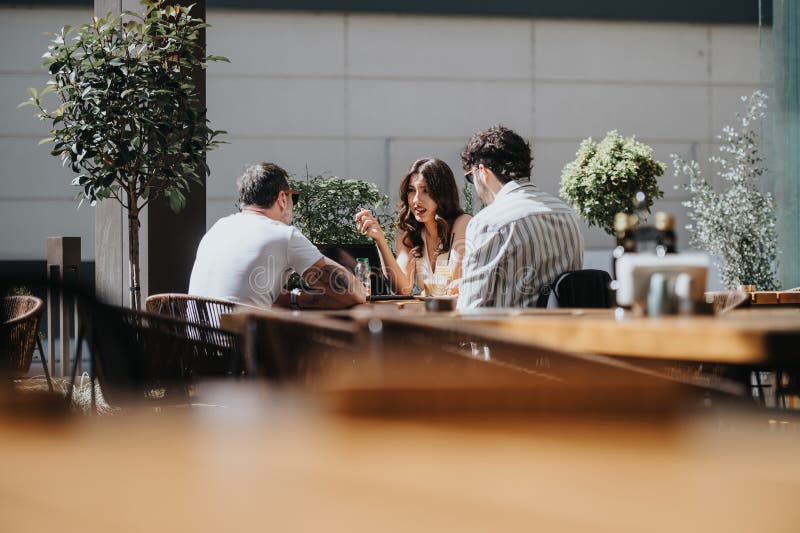 Three entrepreneurs of varying ages engaged in a serious business meeting at a modern coffee shop, reviewing reports and brainstorming growth strategies. Three entrepreneurs of varying ages engaged in a serious business meeting at a modern coffee shop, reviewing reports and brainstorming growth strategies.