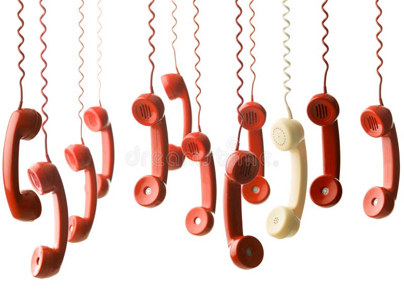 One yellow handset in between many red handsets from vintage phones, hanging against white background. One yellow handset in between many red handsets from vintage phones, hanging against white background