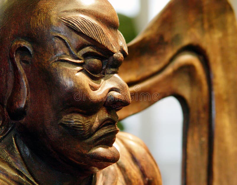 A wood carving of an ancient Japanese statue of a guardian monk used to ward off evil spirits. A wood carving of an ancient Japanese statue of a guardian monk used to ward off evil spirits.