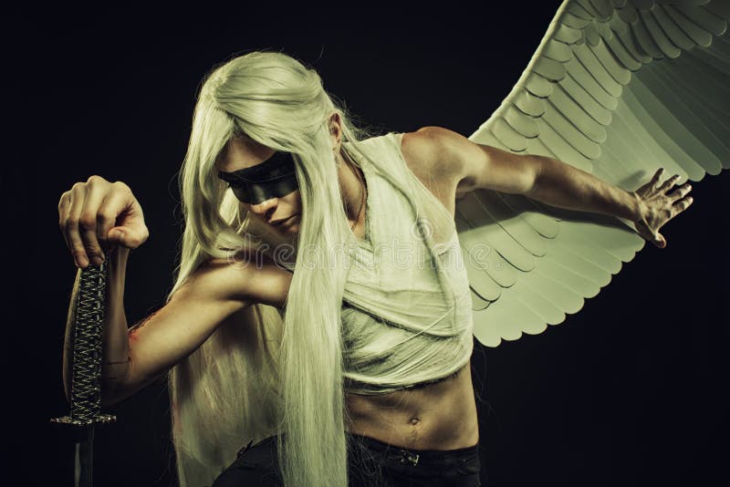 Mighty brave angel posing with katana over dark background. Mighty brave angel posing with katana over dark background