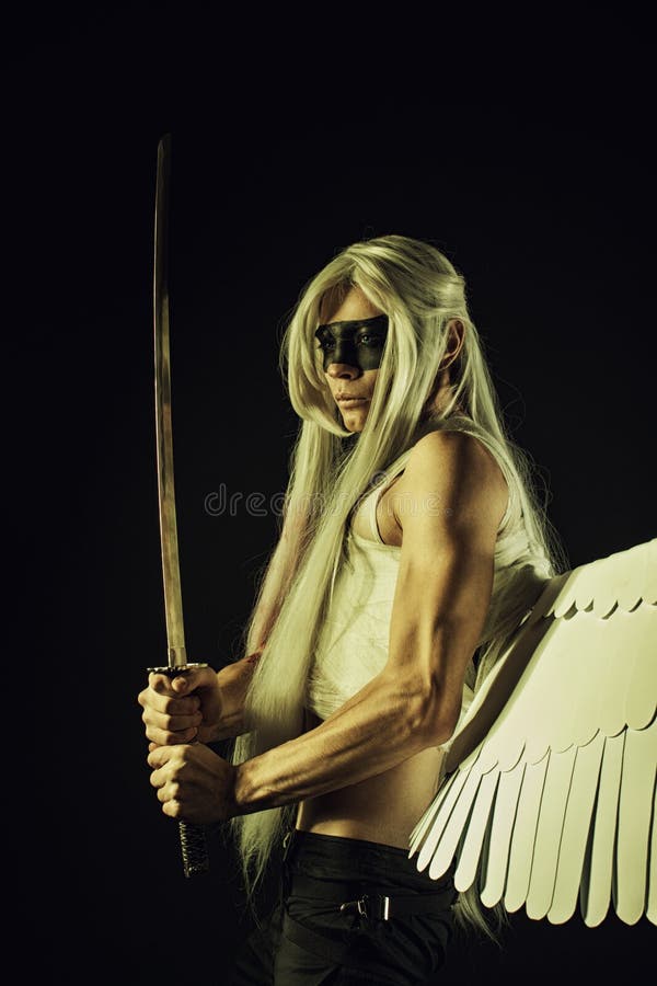 Strong mighty angel with katana posing over dark background. Strong mighty angel with katana posing over dark background