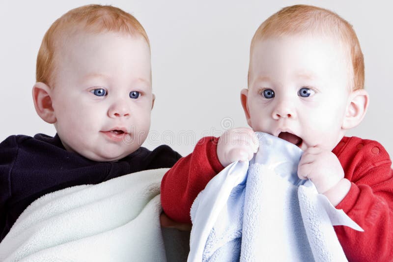 Adorable twin boys with blankets. Adorable twin boys with blankets