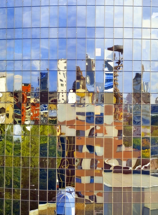 Distorting surrealistic reflection of the city in the mirror wall of a building. Distorting surrealistic reflection of the city in the mirror wall of a building