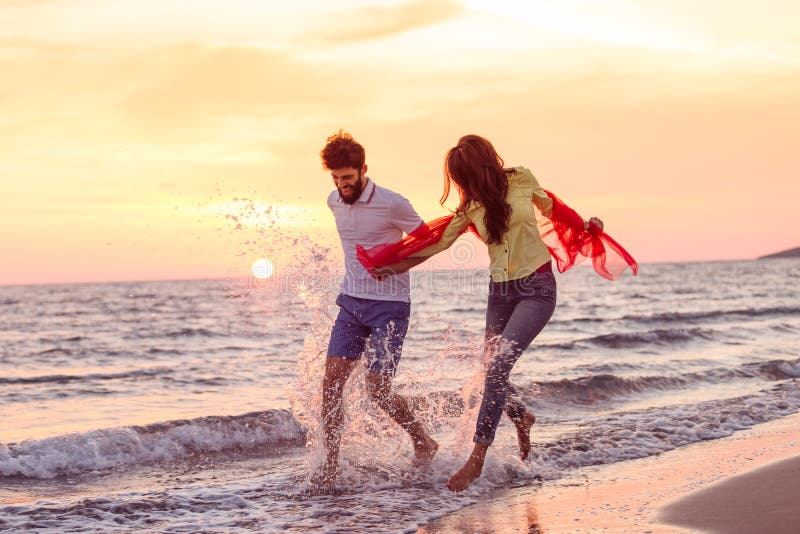 Förälskade lyckliga unga romantiska par har gyckel på den härliga stranden på den härliga sommardagen arkivfoton